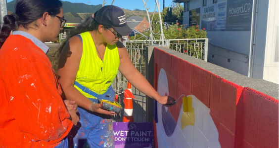 Youth Council member Santino Morehu-Smith, left, gets some tips from visiting artist Taupuruariki Brightwell as work on a new mural in Raumati progresses.