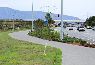 Image showing the pathway beside Kāpiti Road, looking towards the Kāpiti Expressway and Kāpiti Island, and planted with trees and plants