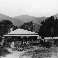 Residence of Charles Whiting in the Valley Road area in 1912 (the house has been demolished). His family and friends are seated on the verandah. To the right are a glasshouse and 1902 Oldsmobile car. thumbnail