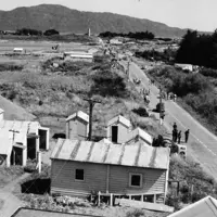 Royal Tour 1953/54 Groups of people walking down Kāpiti Rd towards the beach. thumbnail