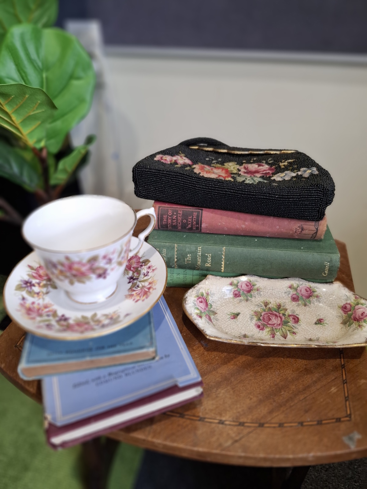 Display of a teacup and old library books for the exhibition of Ōtaki Library, 90 years celebration