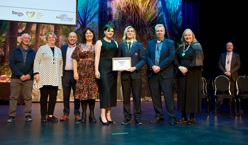 Fletcher Martin and his whānau on stage to accept his Rangatahi Award 28 Aug 2024