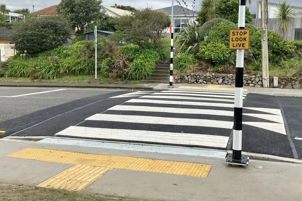 Zebra crossing with a stop, look, live sign