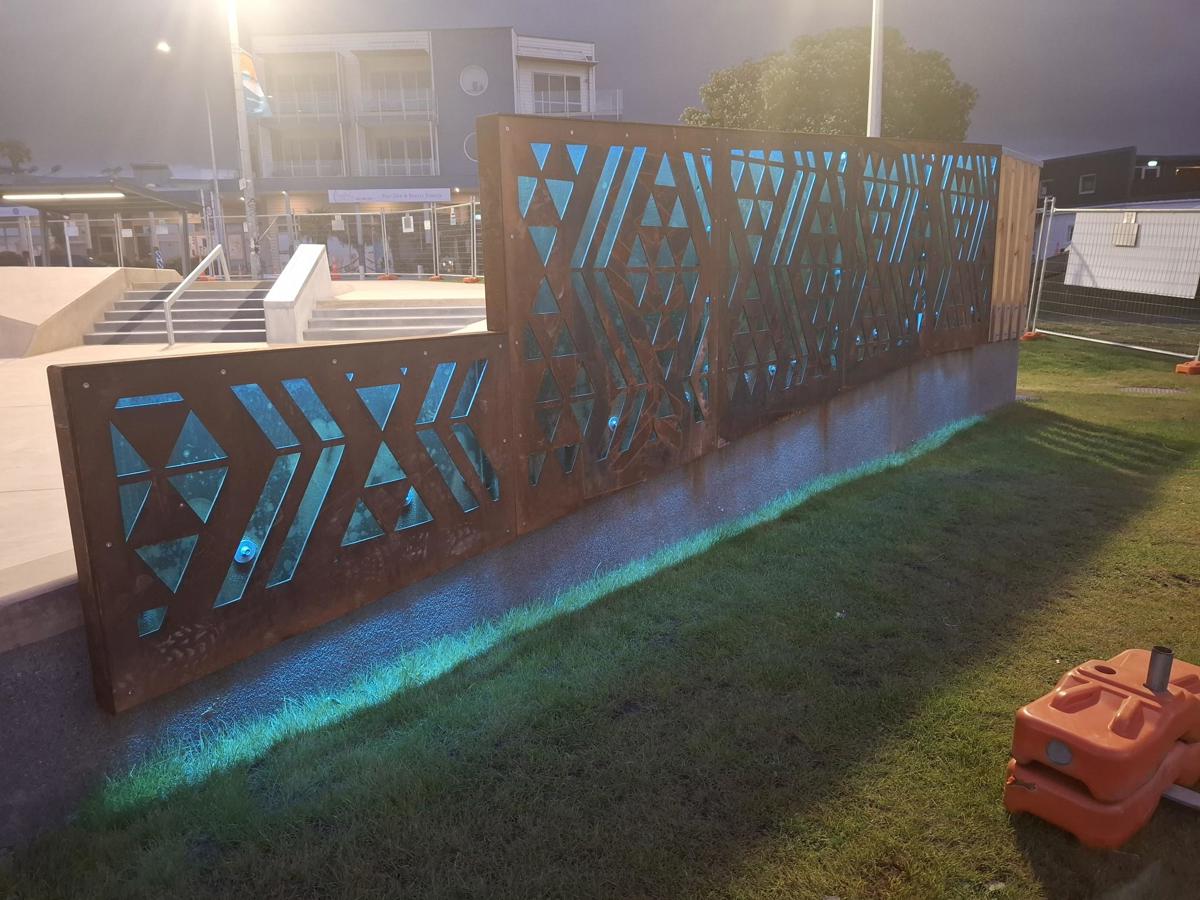 Waharua by artist Kereama Taepa lit up blue at night