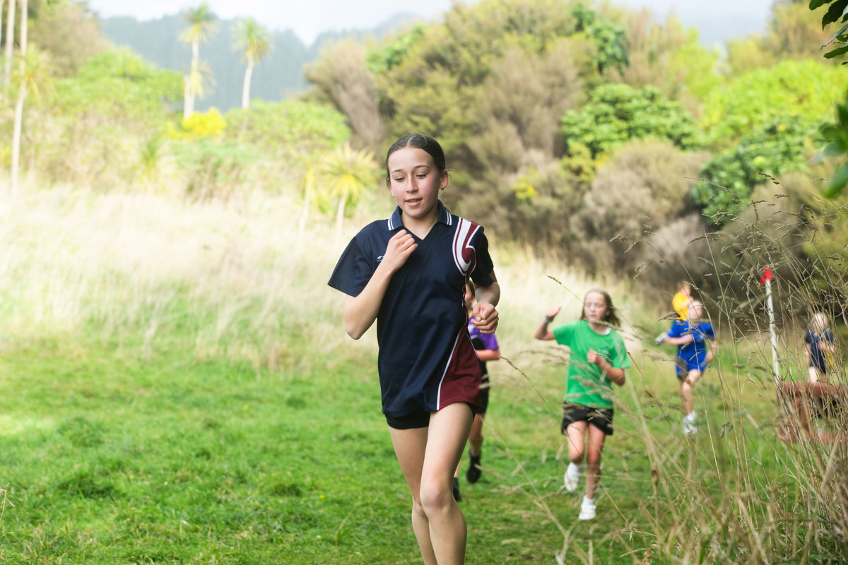 Tamariki running through the bush.