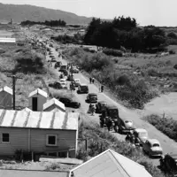 Royal Tour 1953/54 Cars on Kāpiti Road, looking towards Paraparaumu Beach and Kāpiti Island. thumbnail