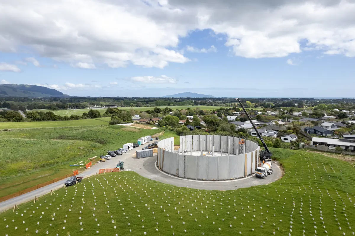 Drone view of the Otaki reservoir surrounded by green fields  