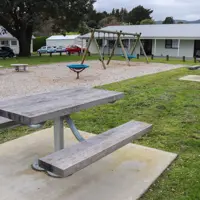 Picnic tables by play area at Matai Road Reserve thumbnail