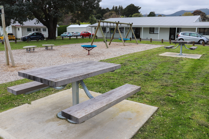 Picnic tables by play area at Matai Road Reserve