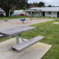 Picnic tables by play area at Matai Road Reserve thumbnail