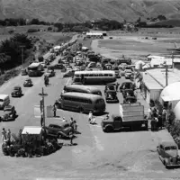 Royal Tour 1953/54 – buses in airport car park, looking up Kāpiti Road towards hills. thumbnail