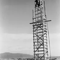 A man on top of the scaffolding during construction in 1958, with Paraparaumu and Kāpiti Island in the background. thumbnail
