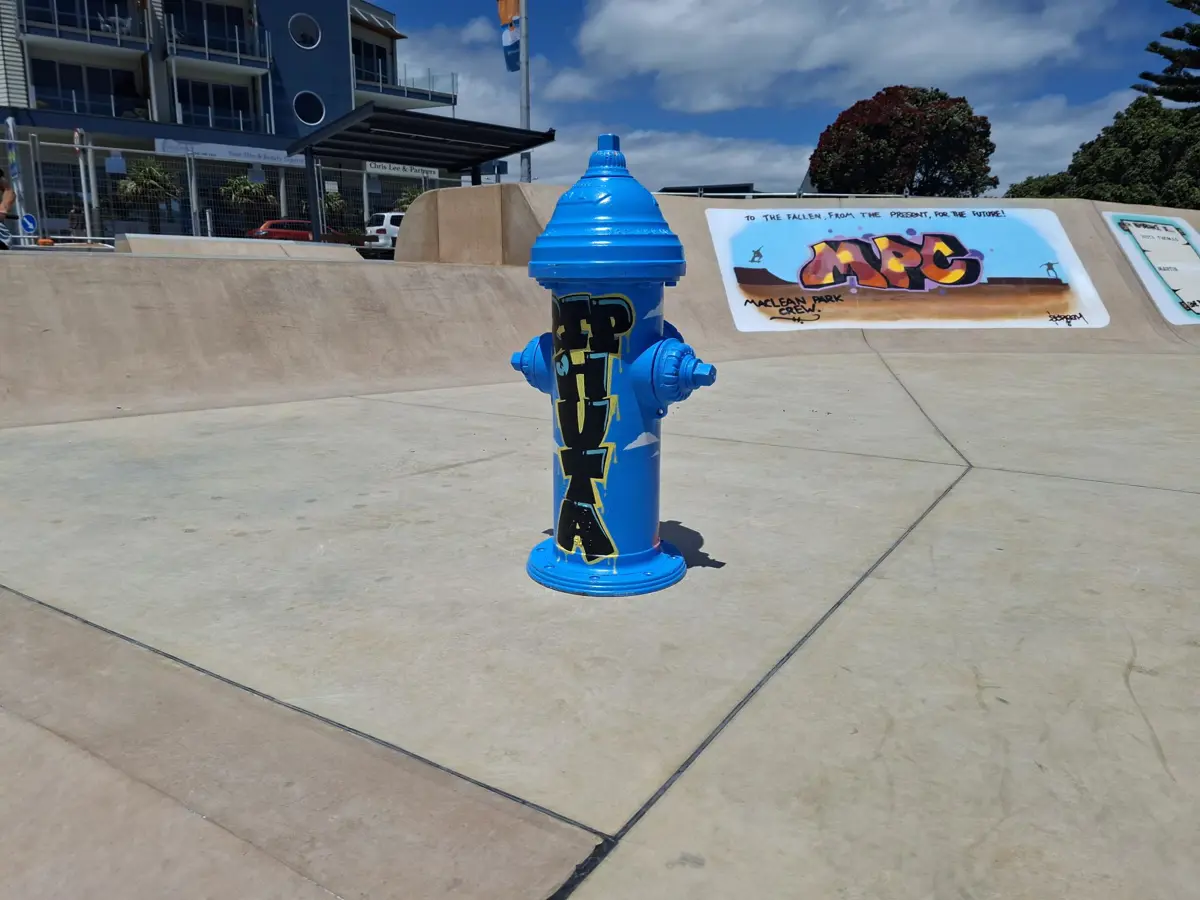 Fire hydrant painted blue with graffiti art by Kane Smith ("Scream")