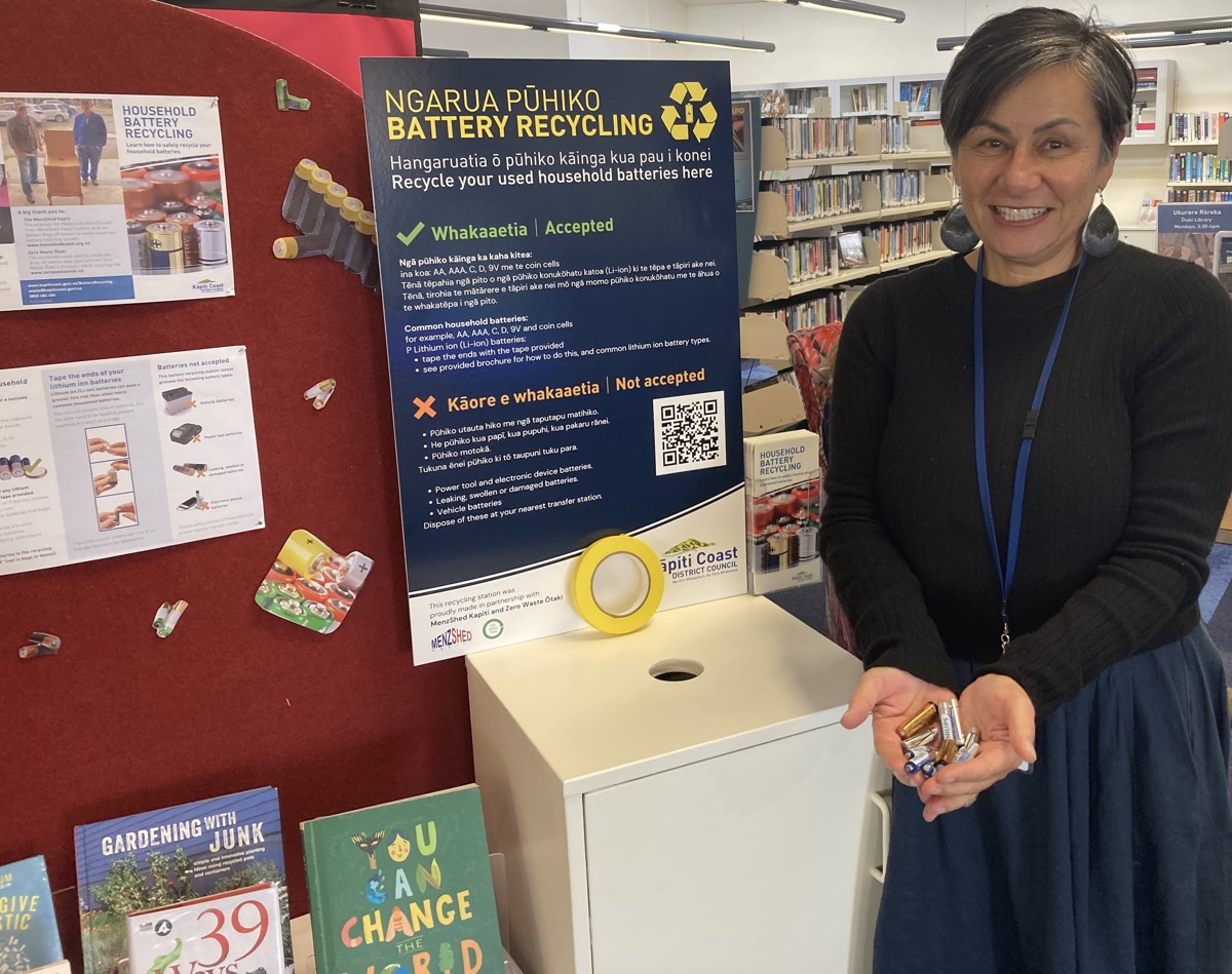 Ōtaki librarian Debbie Brown demonstrates the kinds of batteries you can now recycle at the library.