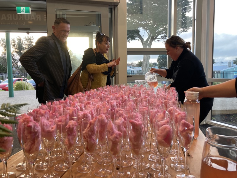Attendees are poured drinks on arrival at Te Raukura ki Kāpiti