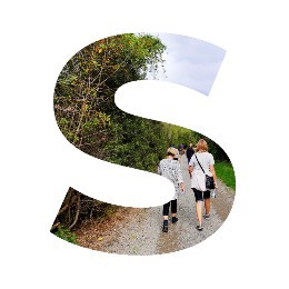 Photo in the shape of the letter "S", with people walking on a track through native trees.