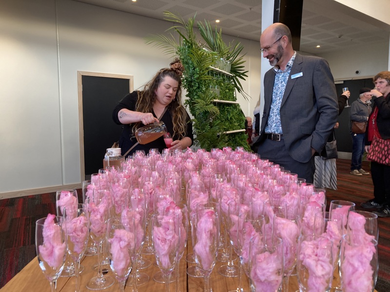 Staff at Te Raukura ki Kāpiti pour a drink for Deputy Mayor Lawrence Kirby