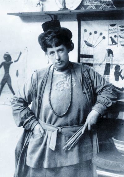 Photo of Frances Hodgkins with some of her artworks around her