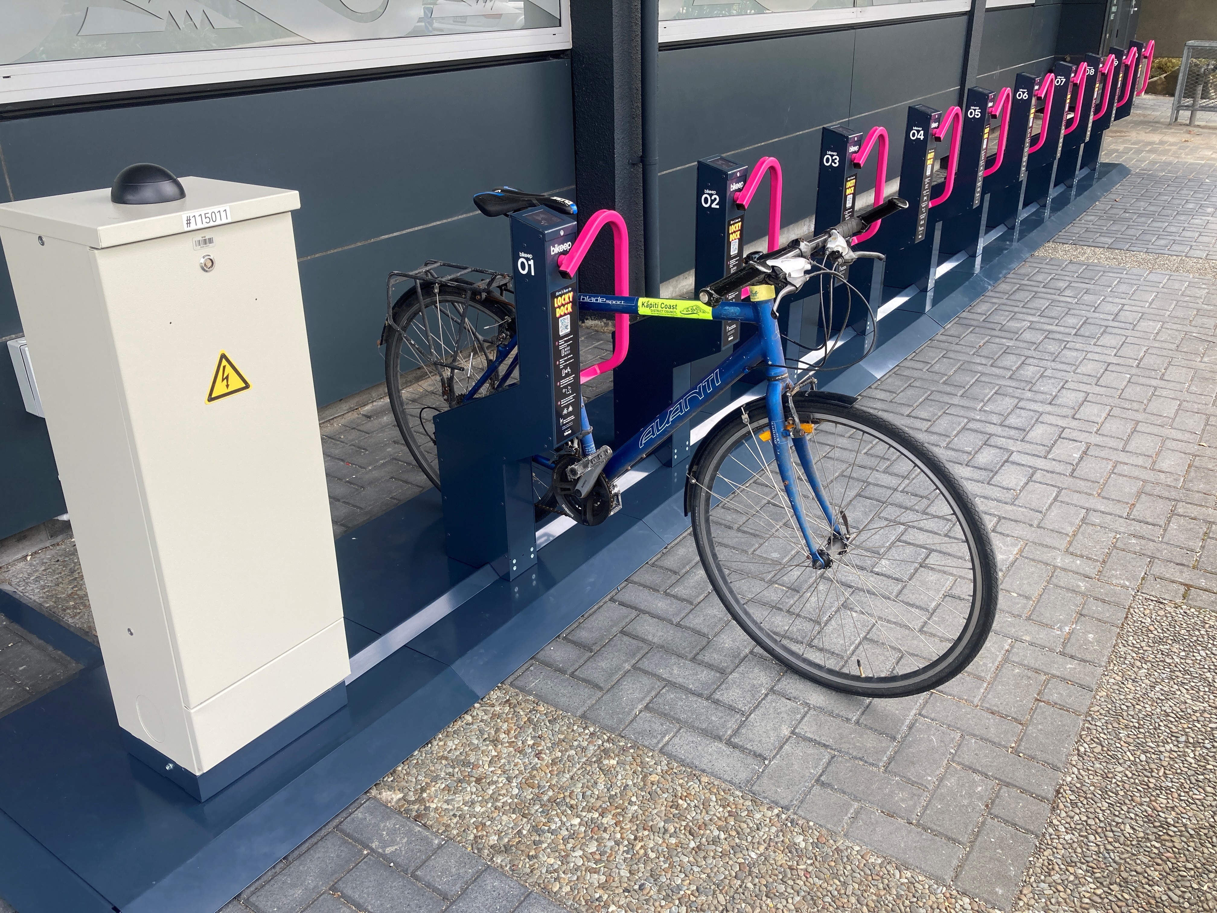 Photo of the locky dock bike stand outside Council offices in Rimu Road, with one bike secured.