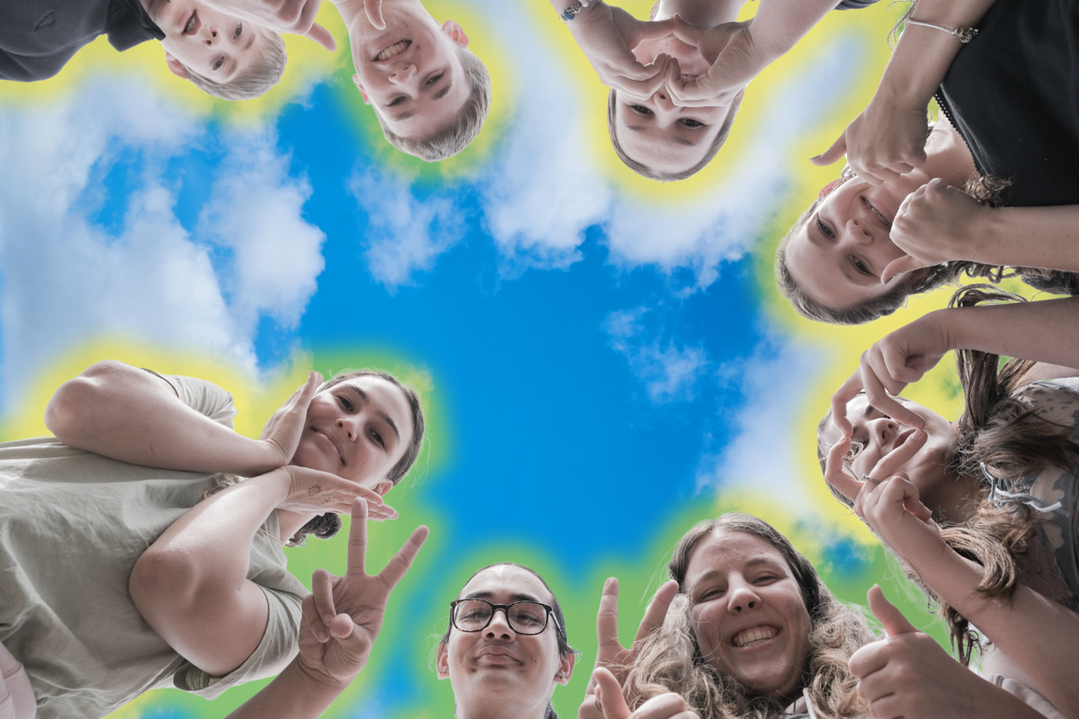 Youth pulling fun faces with the sky in the background