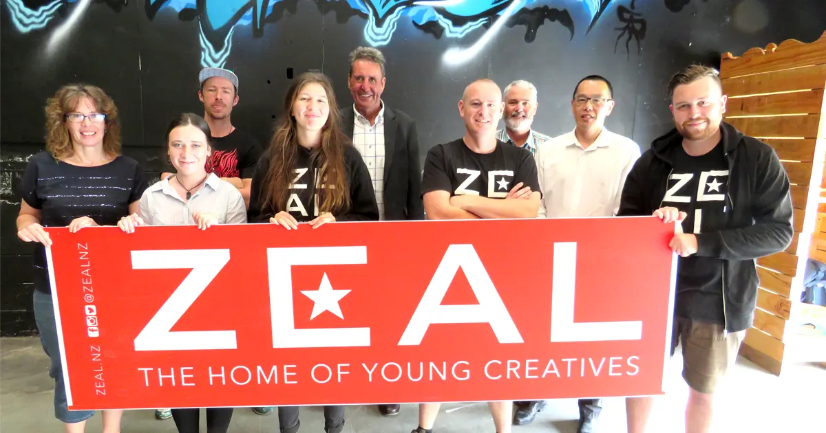 People holding up a zeal sign