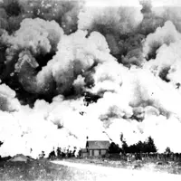 Fire in the Reikōrangi Valley in 1908. The church is St Andrew’s on the corner of Reikōrangi Rd and Akatarawa Rd. The fire burned from the ranges to the sea, the trains couldn’t run and the roads were closed Hp 2007, Wilf Wright Collection, KCD Libraries. thumbnail