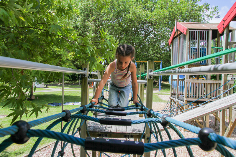 Climbing the rope bridge at Haruātai Park