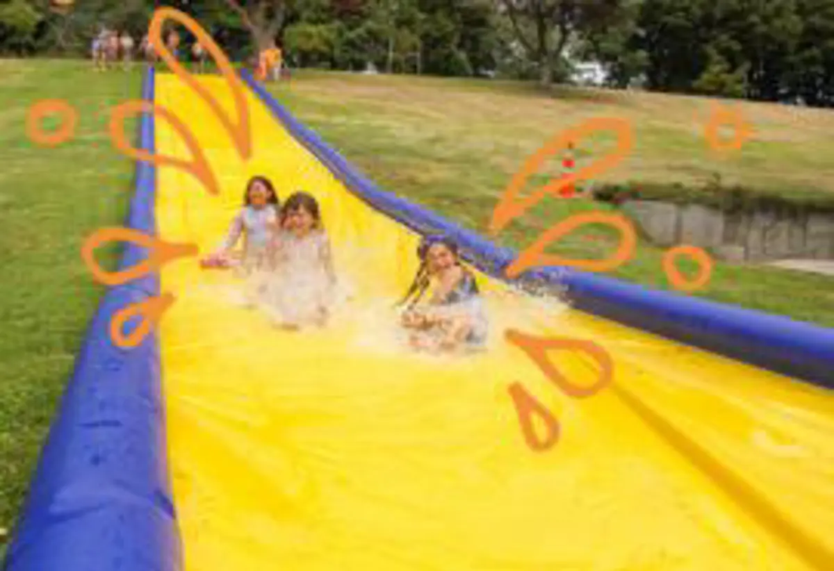 Children sliding down a water slide