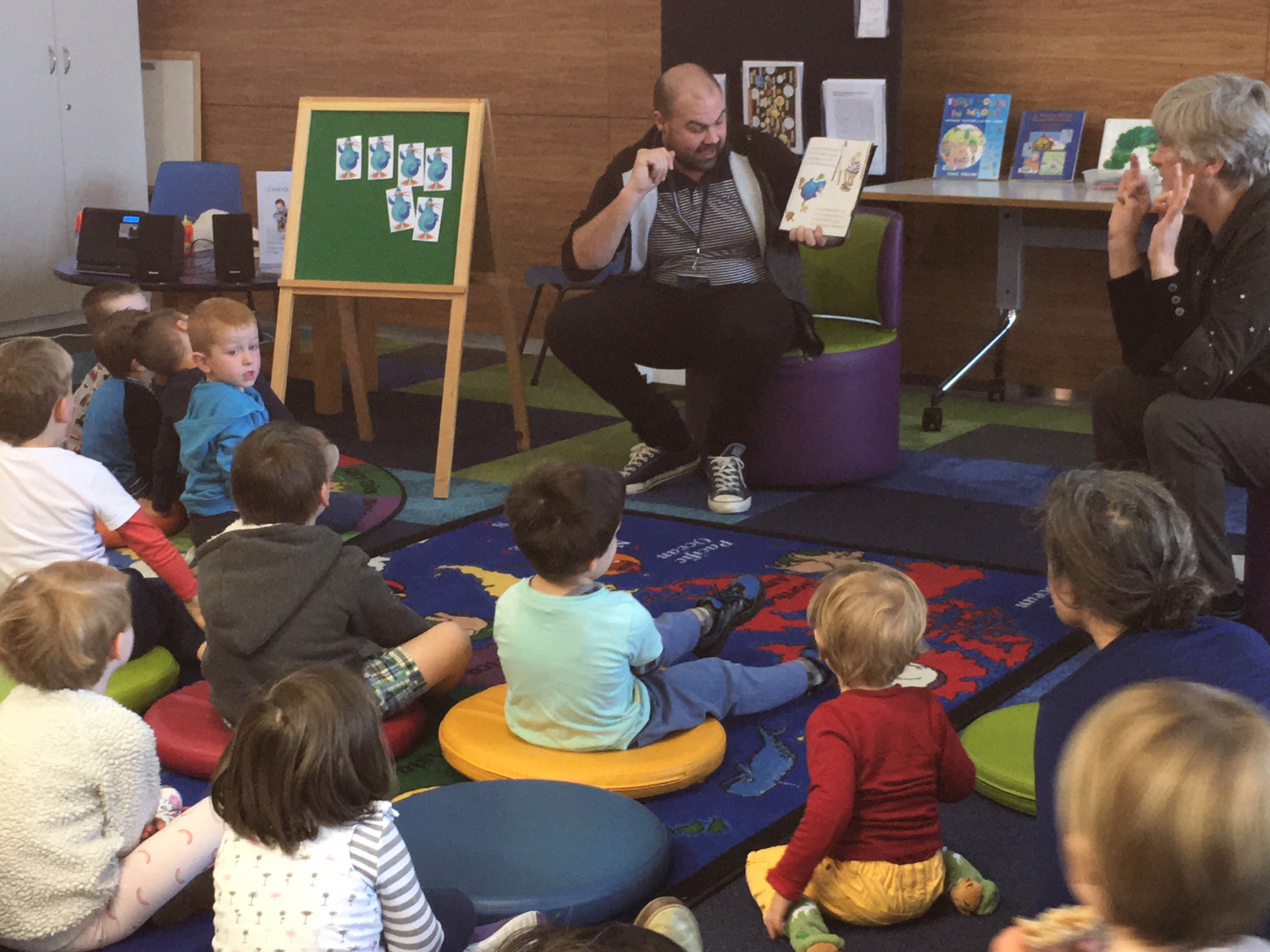 Image of librarian reading in Te Reo to a group of children