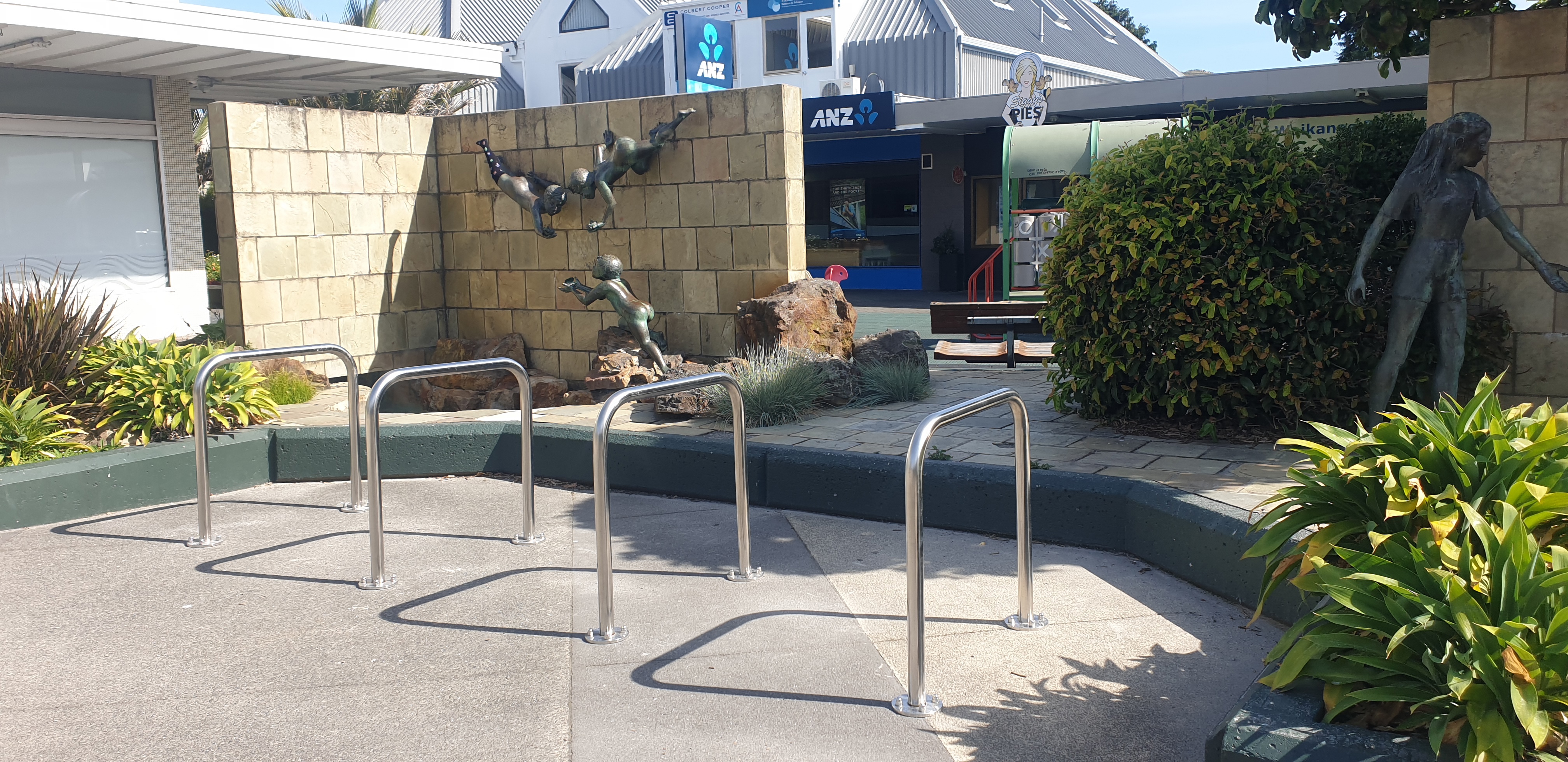Photo of the bike stand in Mahara Place Waikanae, with the water feature in the background.