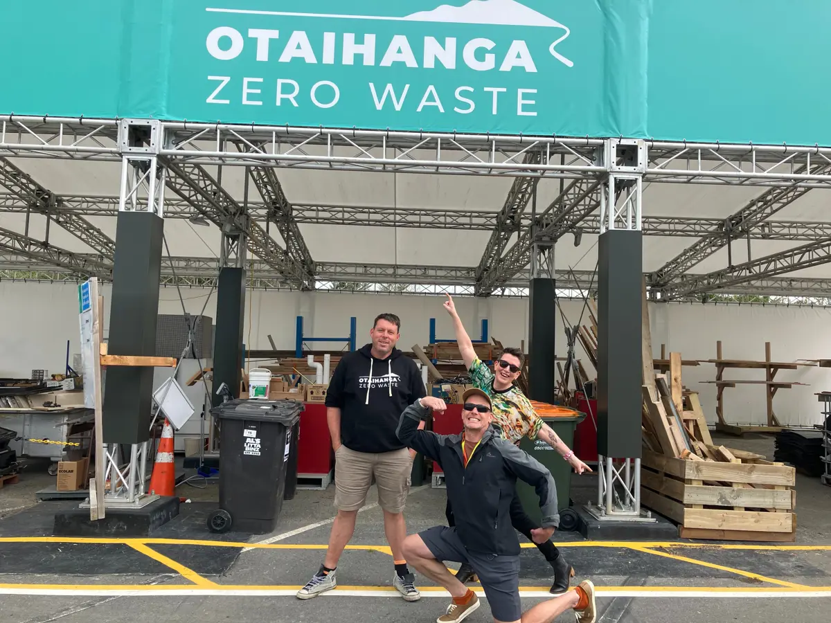 Otaihanga Zero Waste site with people standing in front of a covered recycling and reuse area, showing pallets, bins and construction materials