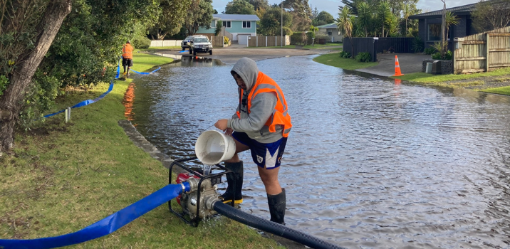 Council staff pumping water from a flood in one of our Kāpiti residential streets