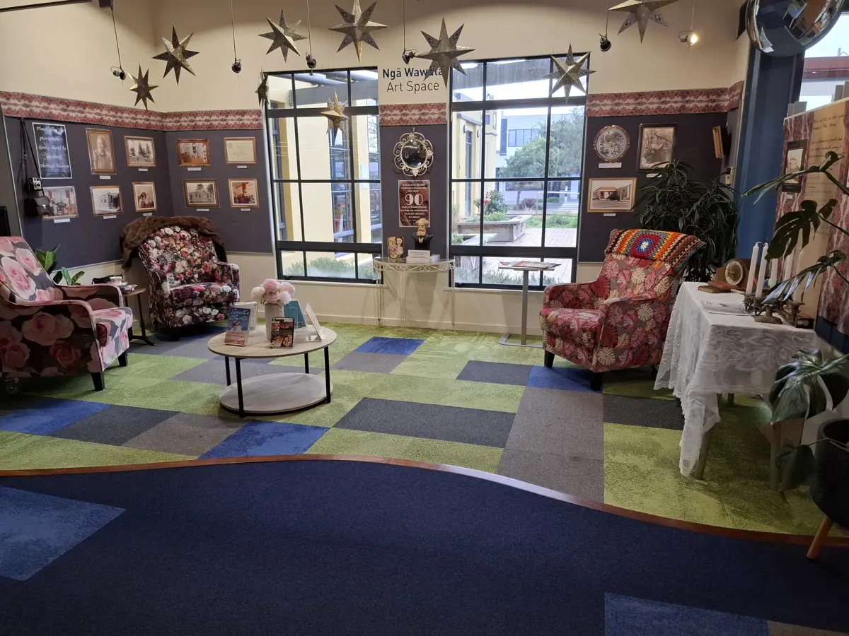 Interior photo of Ōtaki library in modern days with a star display and comfy chairs to chill out and read
