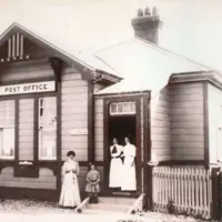 Photograph of the exterior of the Waikanae Post Office, 1910. The people are postmistress Mrs AE Matthews and her staff. Kāpiti Coast Museum Collection. thumbnail