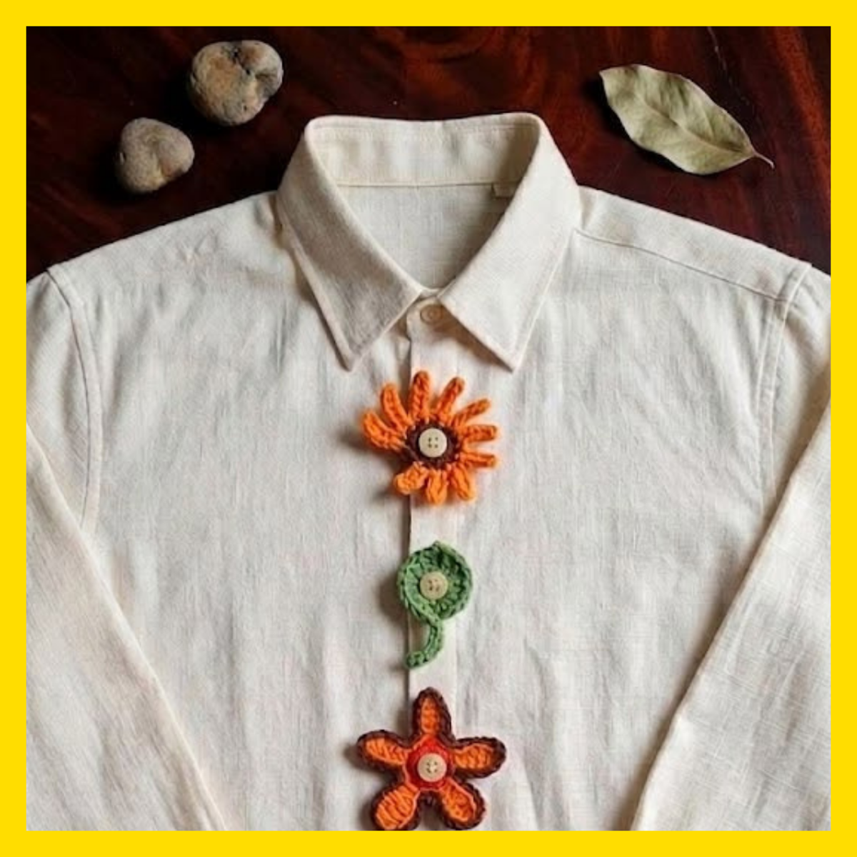 White shirt with crocheted button covers. A flower, koru and star