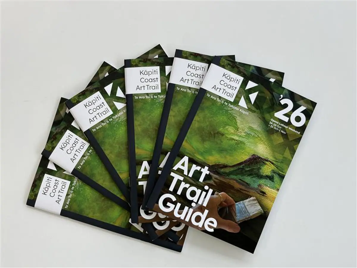 Kāpiti Coast Art Trail guide booklets displayed in a fan arrangement.