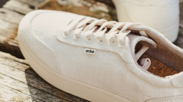 Orba white sneaker on wooden bench