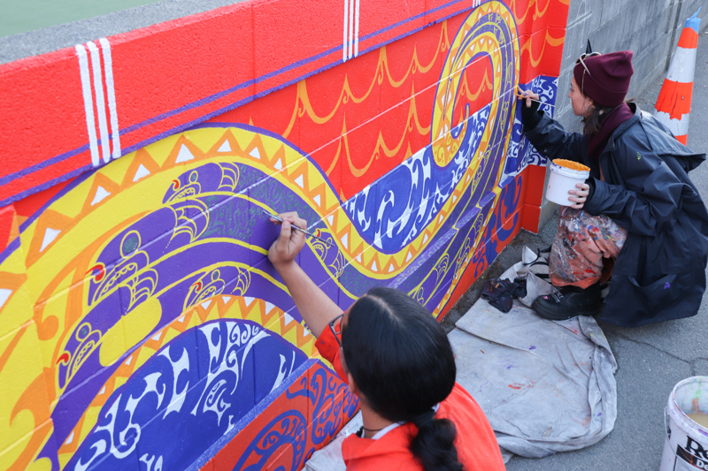 Taiohi (young people) helping create the mural
